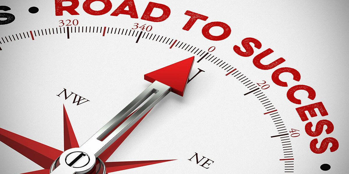 Compass arrow points to the words "Road to Success"