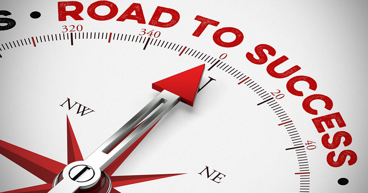 Compass arrow points to the words "Road to Success"